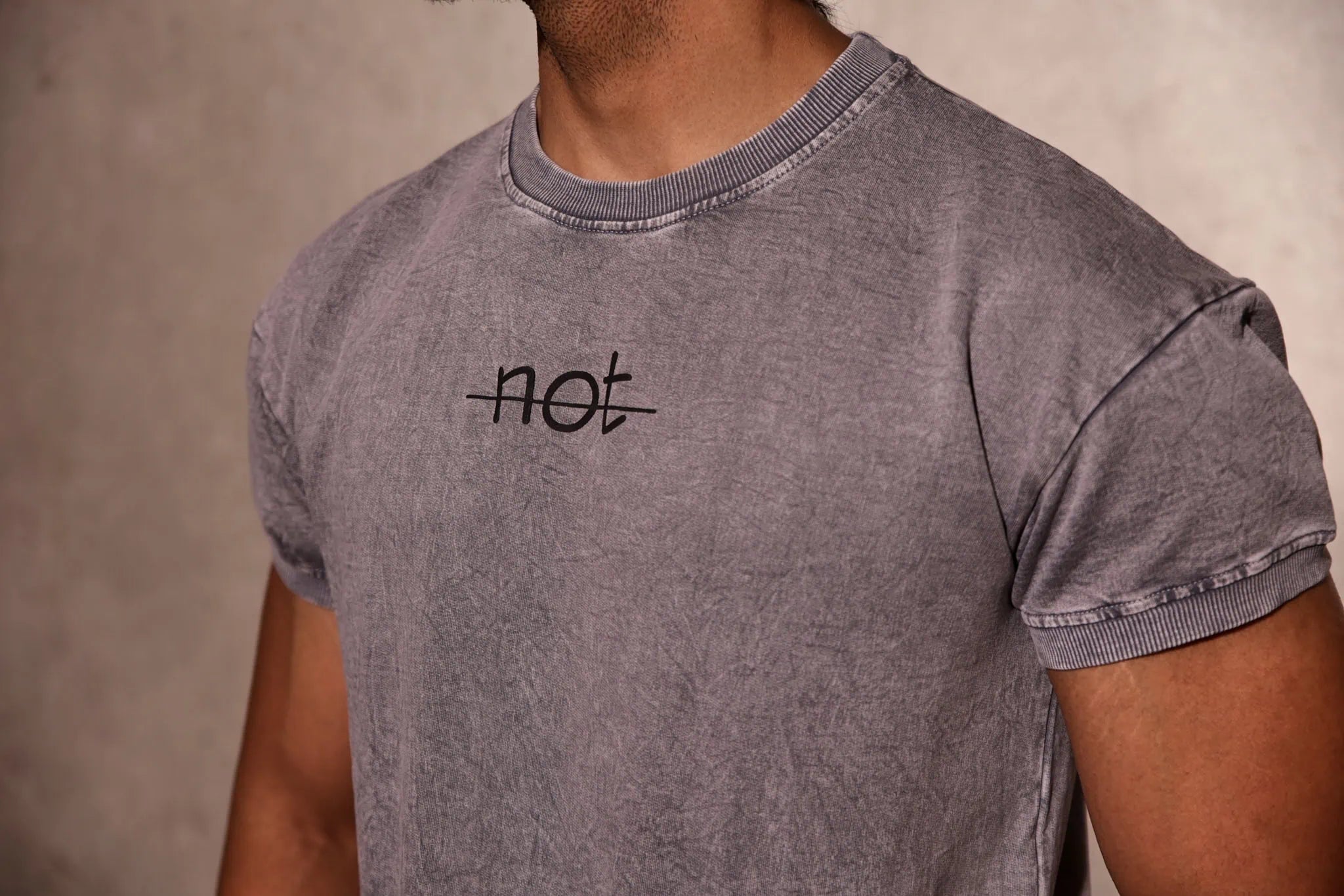 Gray t-shirt with 'not' text on a neutral background