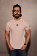 Man wearing glasses and a light-colored t-shirt against a plain background